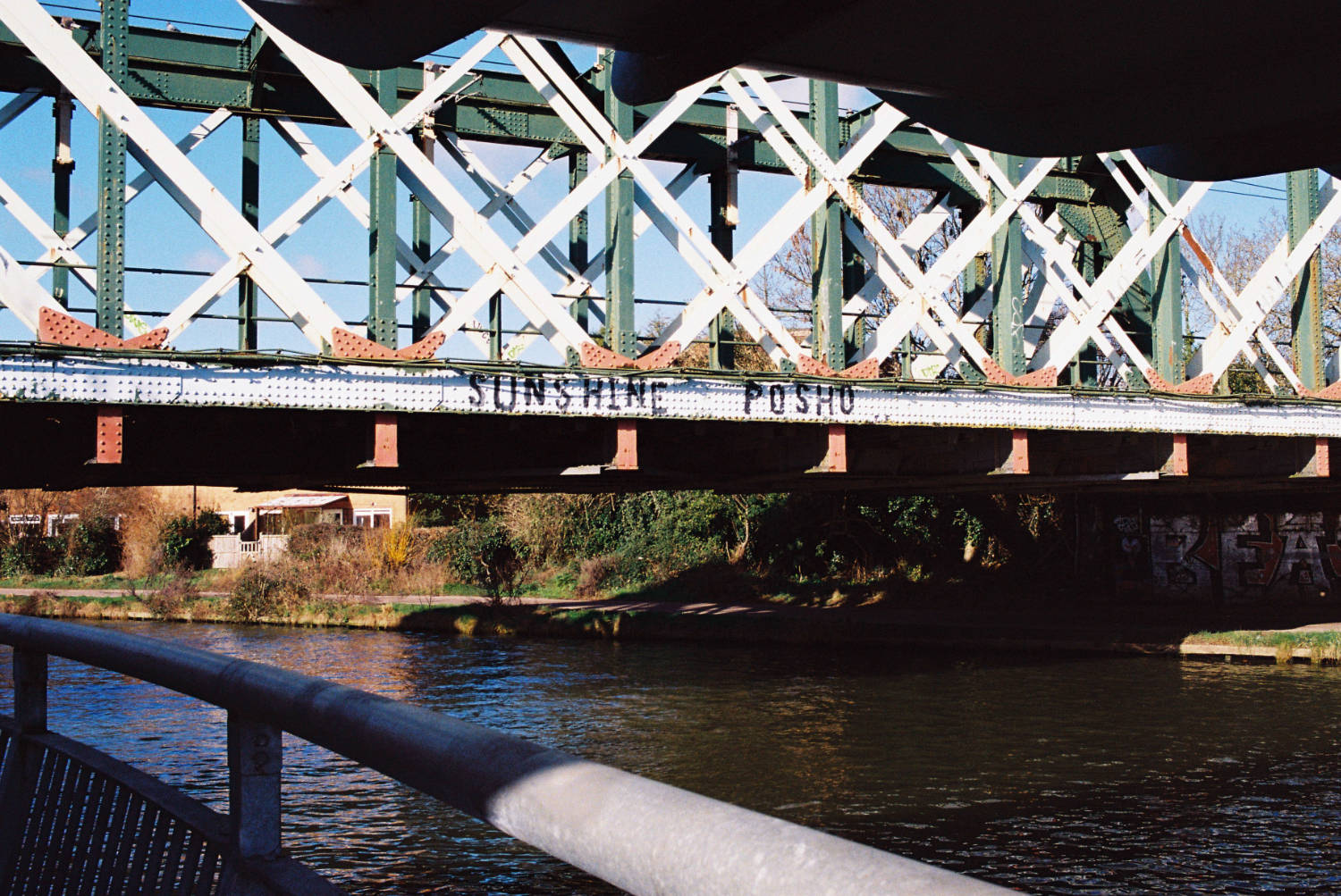 Railway Bridge over the River Cam. Graffiti reads 'SUNSHINE POSHO'.
